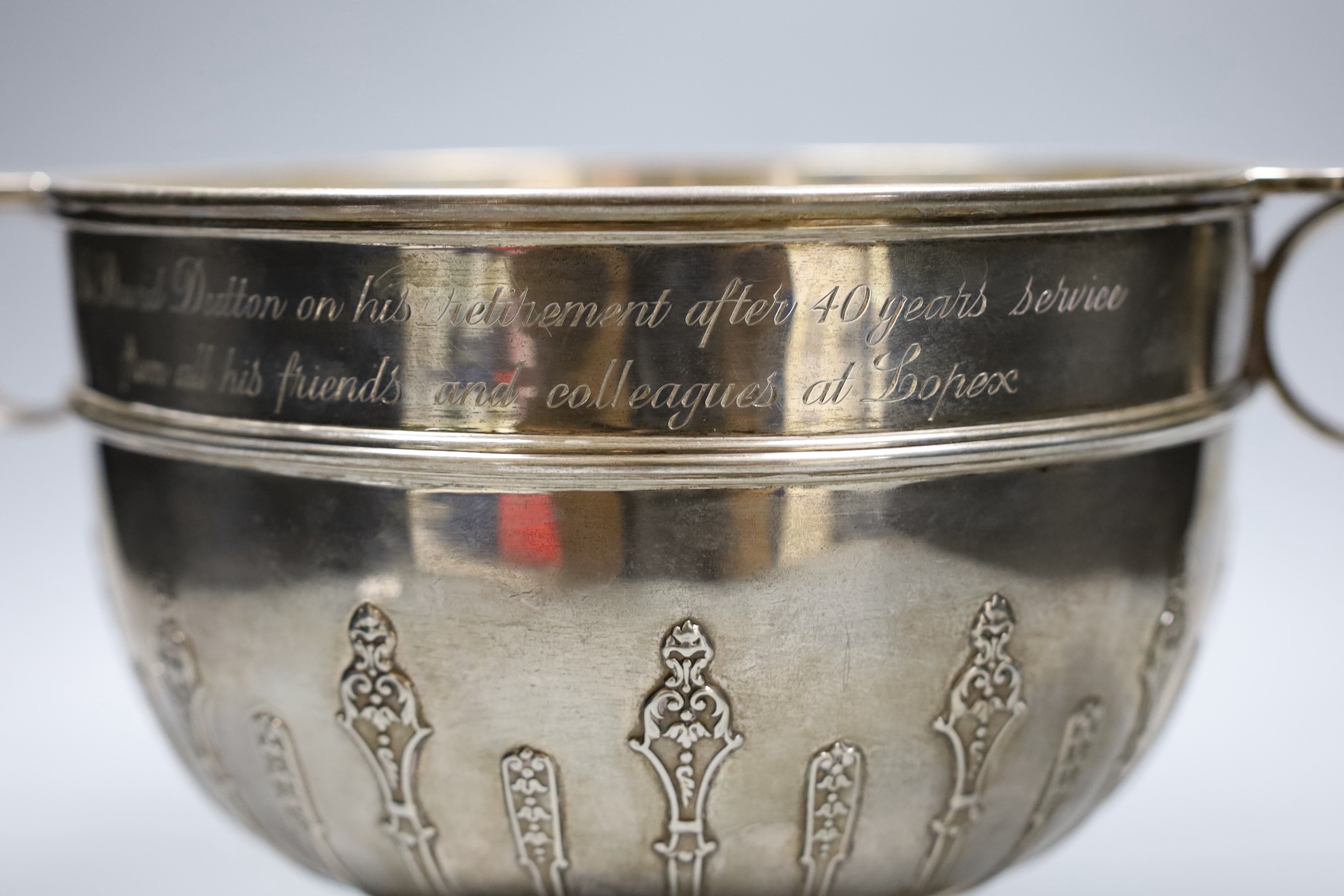 A late Victorian two handled silver rose bowl, with strapwork decoration and later presentation inscription, London 1900, 1532 grams, 35cm over handles, height 18cm